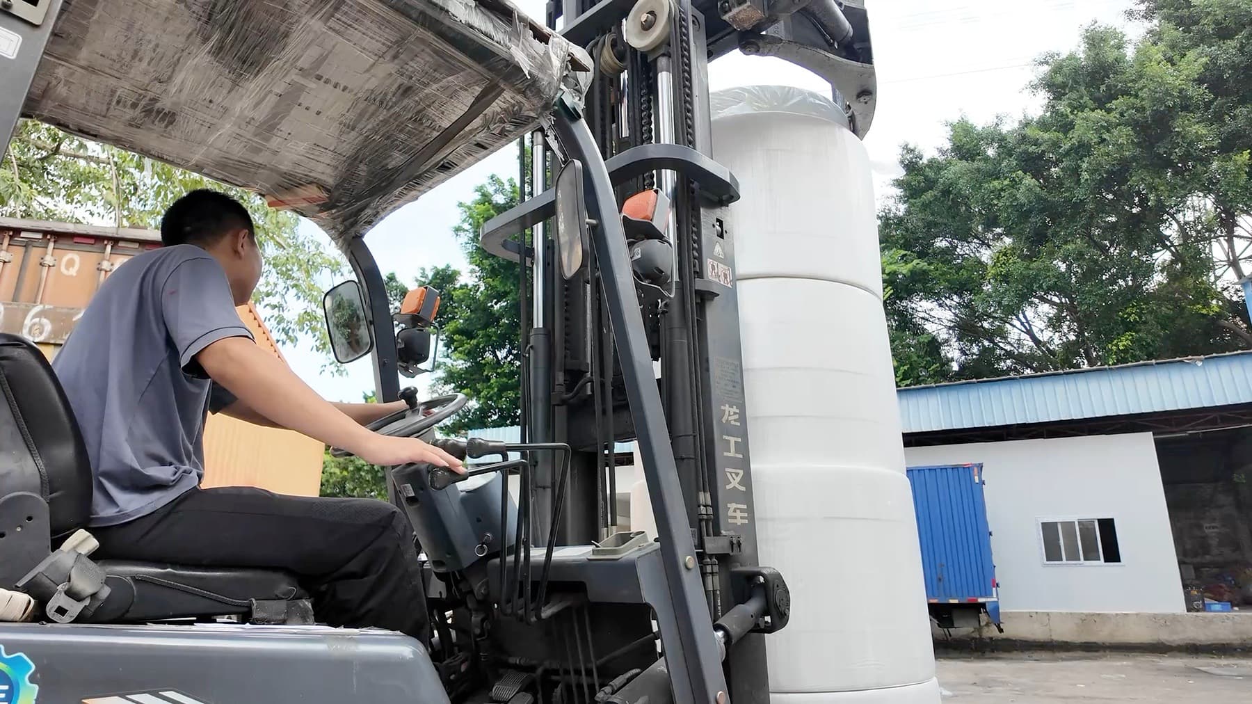 Jiufeng worker moving a wrapped parent tissue roll for material preparation in Dongguan