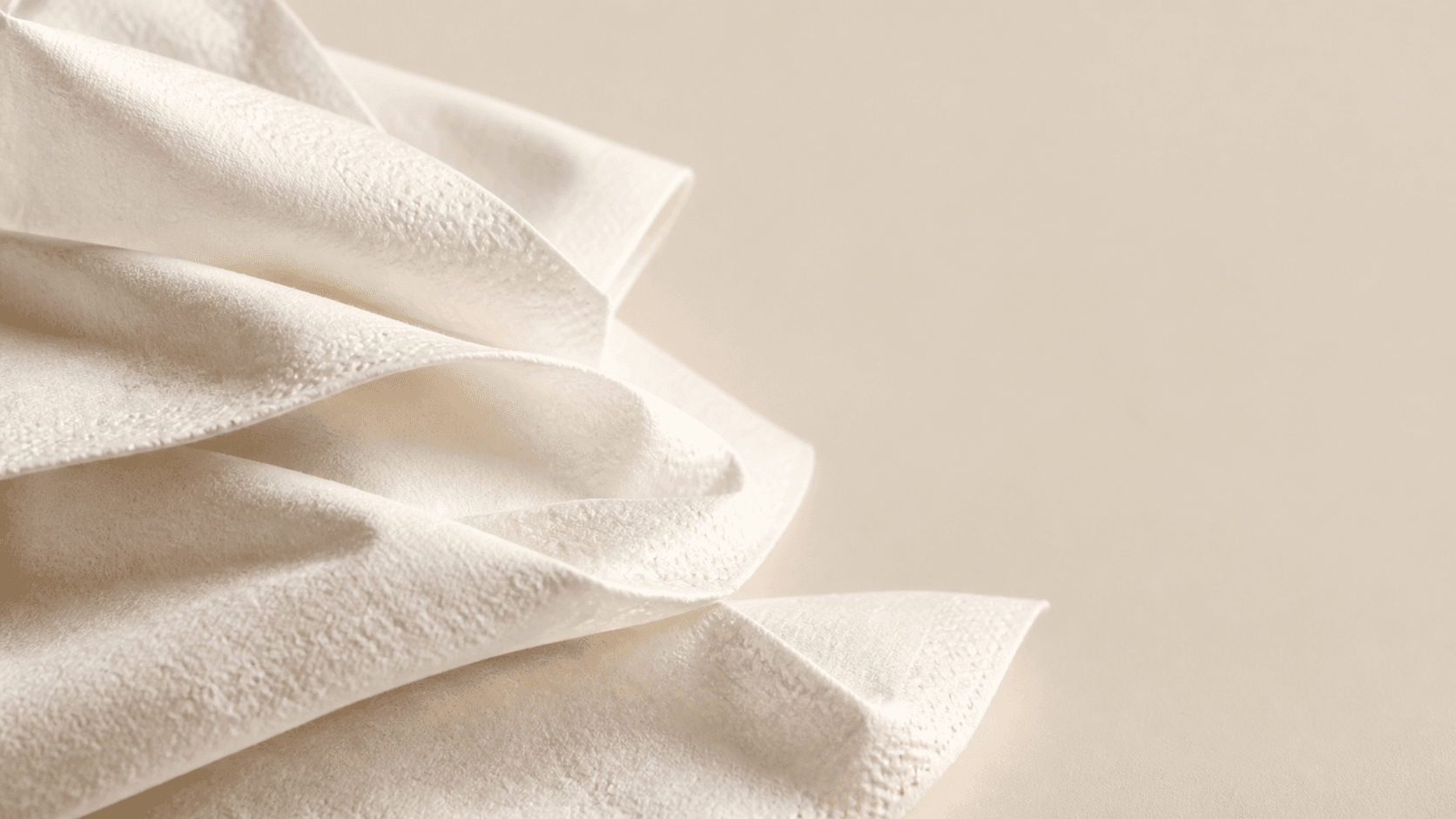 Soft folded tissue texture behind the final project inquiry call to action